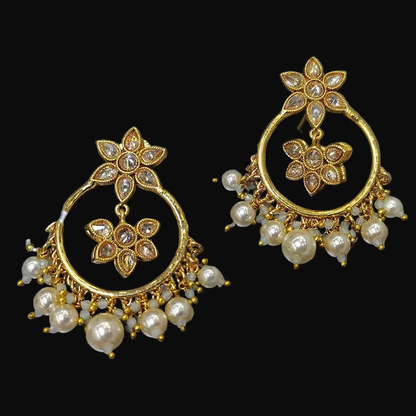 Gold and pearl earrings on a gray background with 'Saheli' branding.