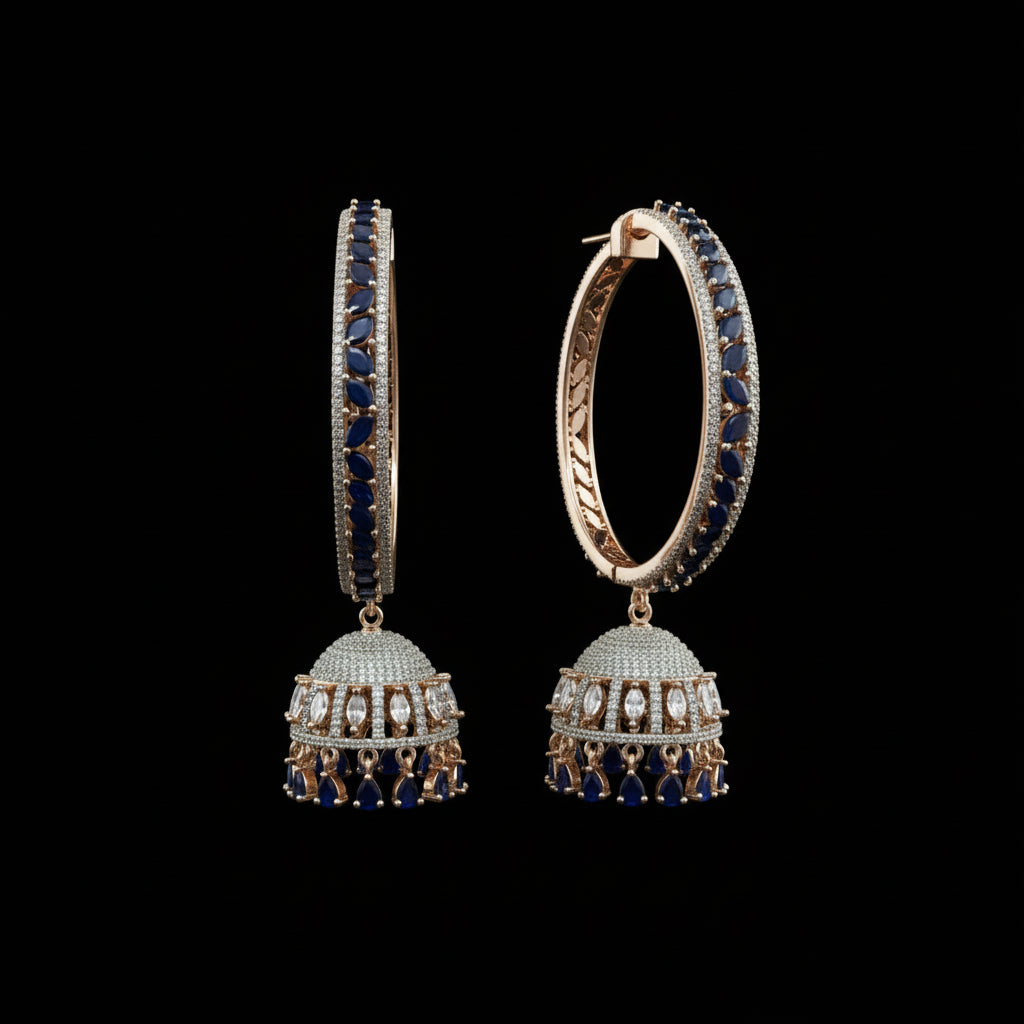 Pair of ornate earrings with blue stones on a gray background