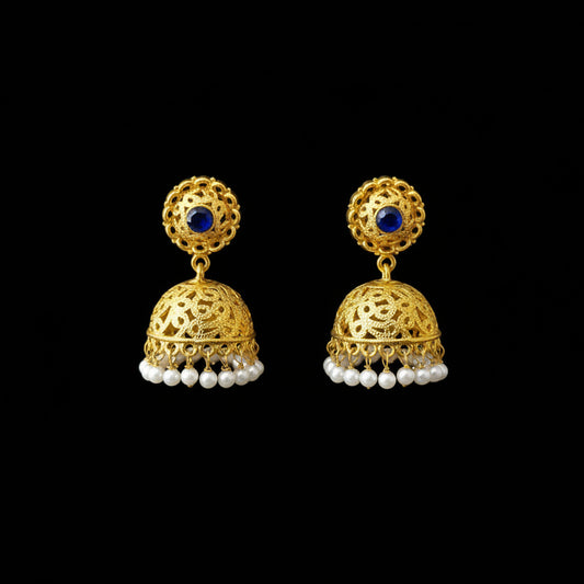 Gold earrings with blue stones and pearl accents on a gray stand, branded 'Saheili'.