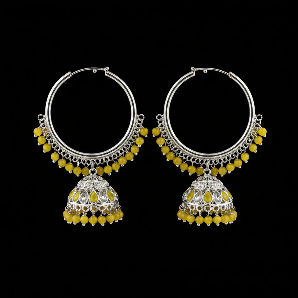 Pair of silver hoop earrings with yellow beads on a black background
