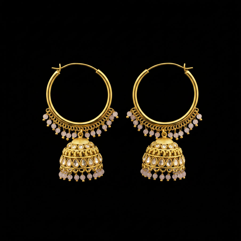 Gold hoop earrings with intricate designs on a gray background