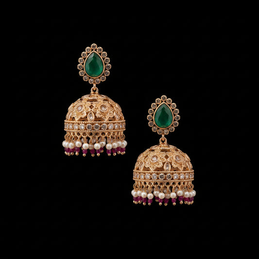 Gold and green earrings on a gray stand with HP logo in the background