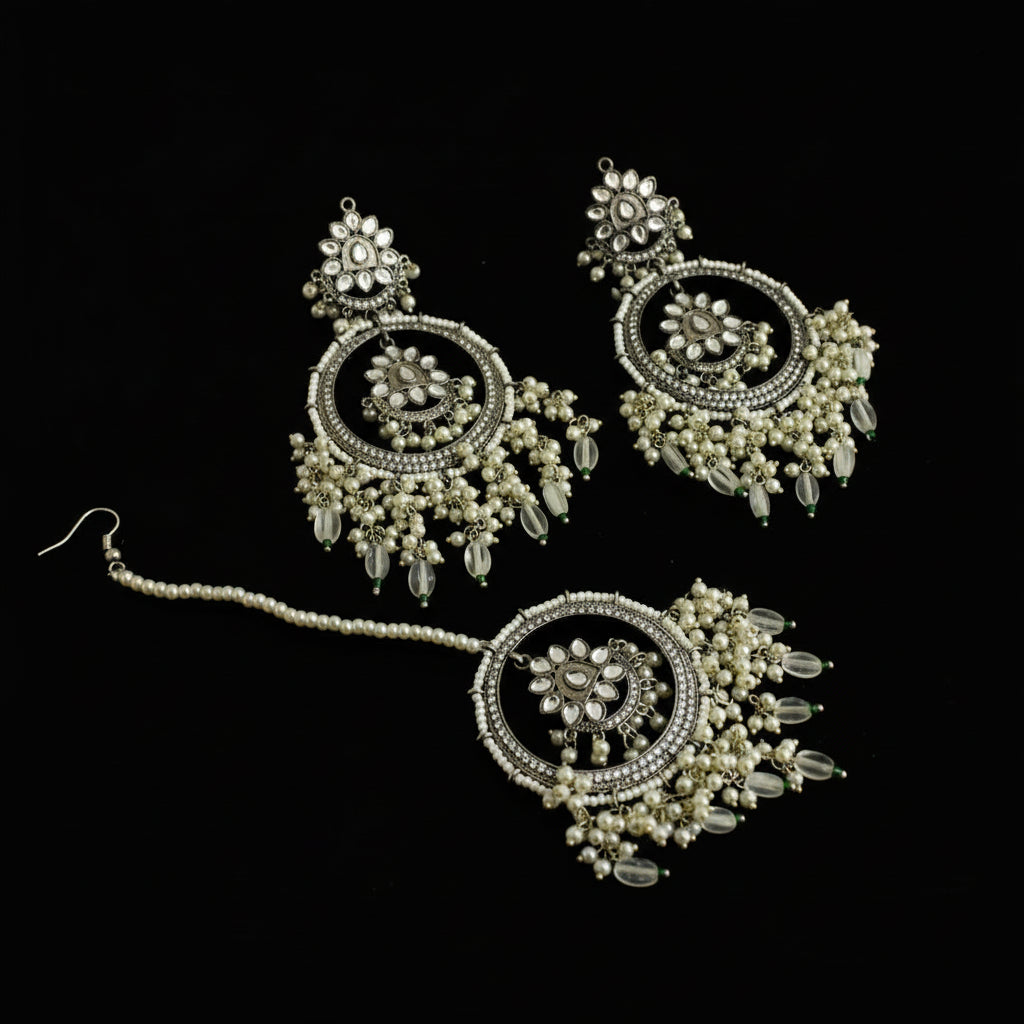 Ornate silver and pearl jewelry set on a dark background with 'SAHELI' branding.
