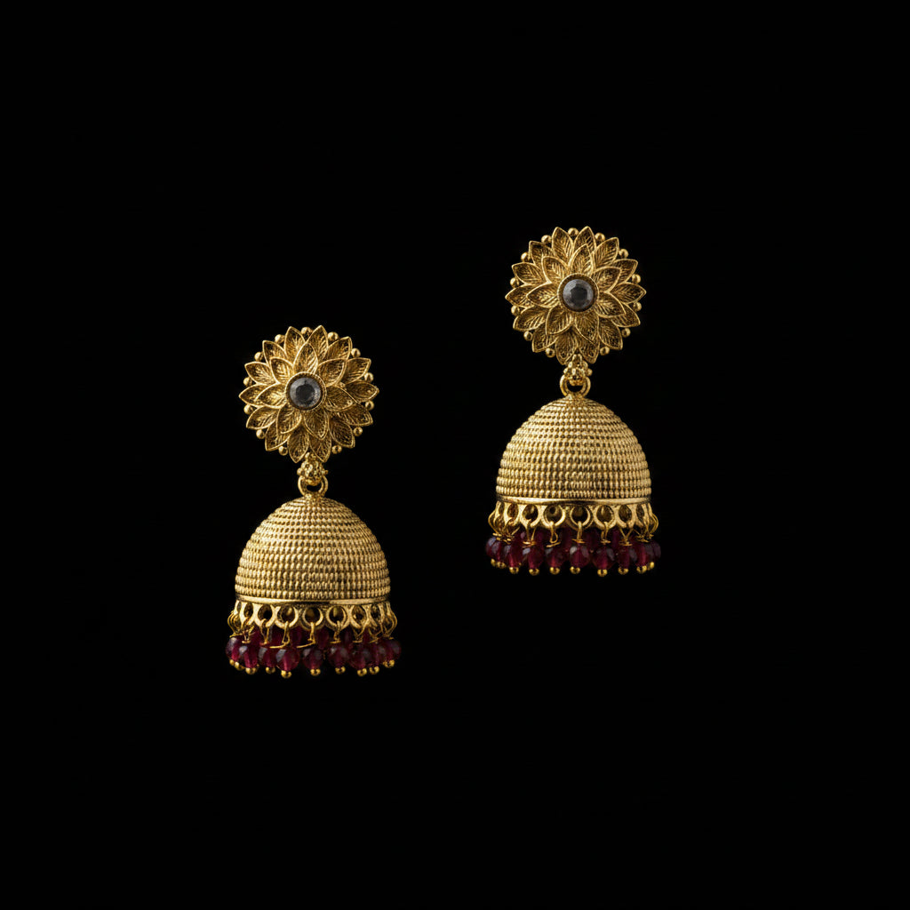 Gold earrings with red stones on a black stand against a gray background with HP logo.