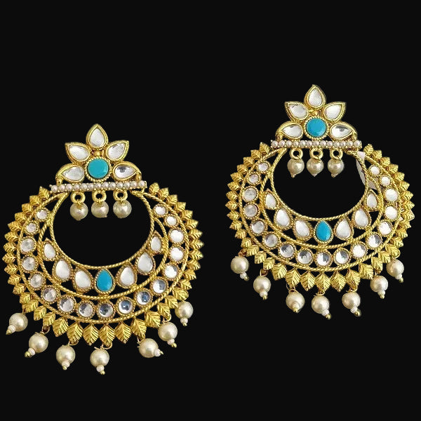 Pair of gold earrings with pearls and turquoise stones on a dark background, branded 'Saheli'.