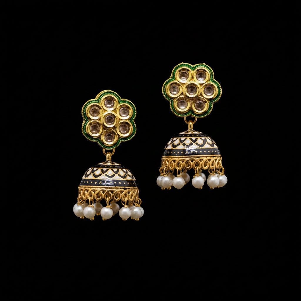 Gold and pearl earrings on a stand with 'Saheli' branding.