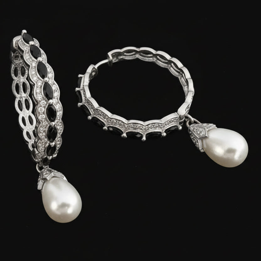 Jewelry set with earrings and ring featuring pearls and rubies on a dark background, branded 'SAHELI'.