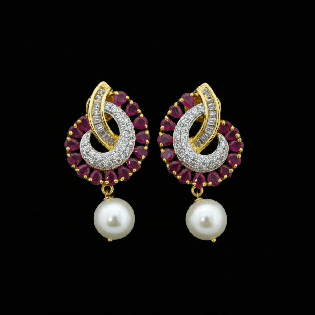 Pair of gold and red gemstone earrings with pearls on a dark background, branded 'Saheli'.