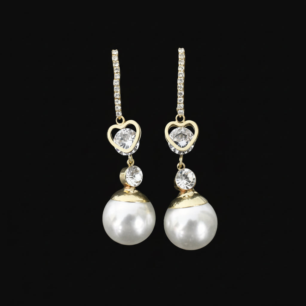 Pearl and diamond earrings on a black stand against a dark background