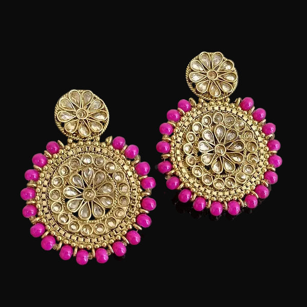 Gold and pink earrings on a dark background with 'SAHELI' branding.