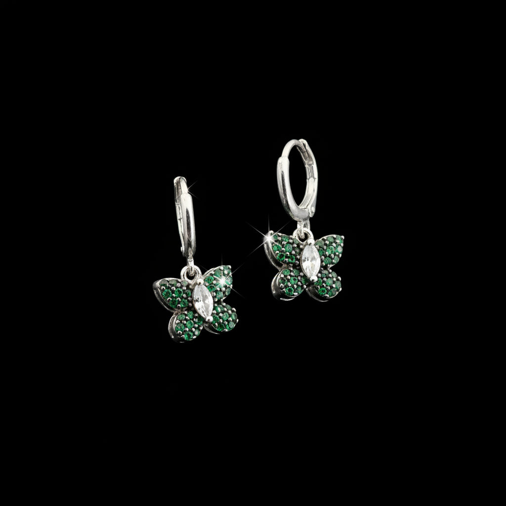 Pair of silver earrings with green gemstones on a gray background, featuring the brand 'Saheli'.