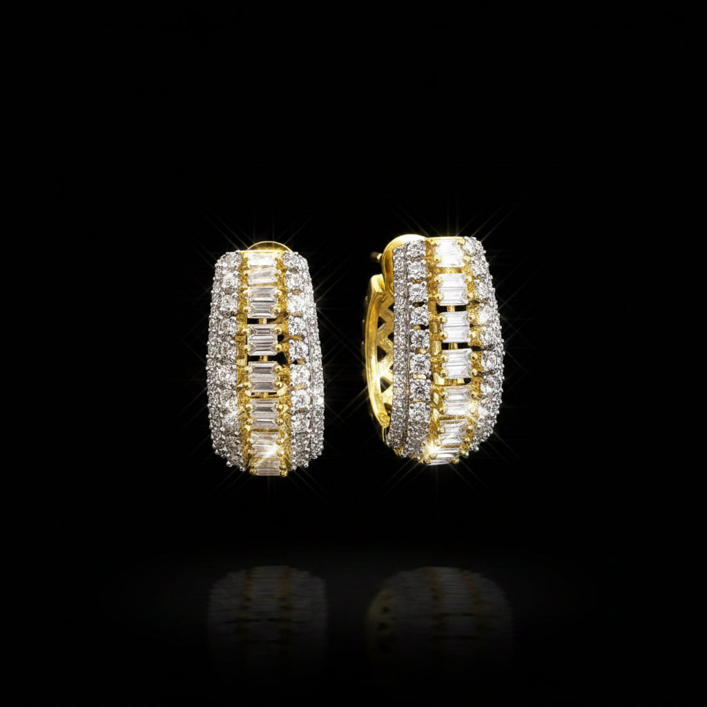 Gold and silver hoop earrings on a gray background with 'Saheili' branding.