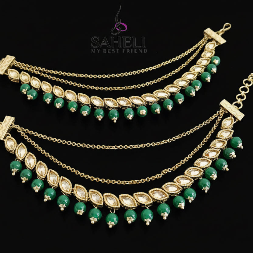 Gold and green necklace with 'Saheli' branding on a dark background