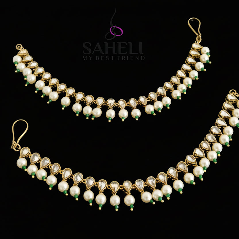 Pearl necklace with gold accents on a dark background, featuring the brand 'Saheli'.