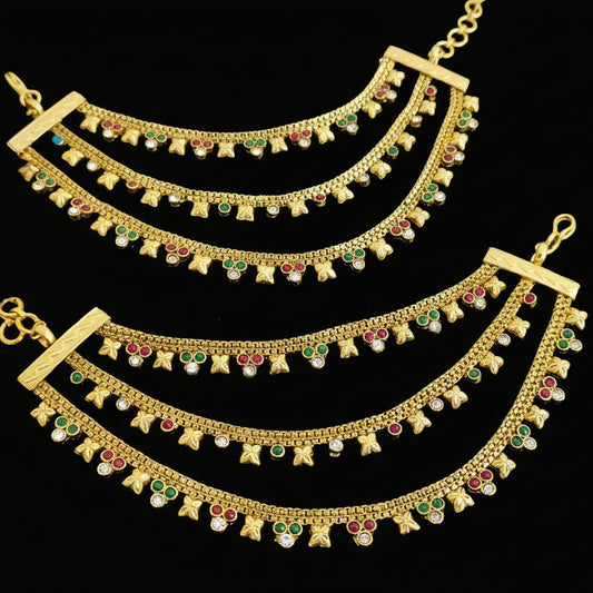 Two gold necklaces with gemstones on a dark background, branded 'SAHELL'.