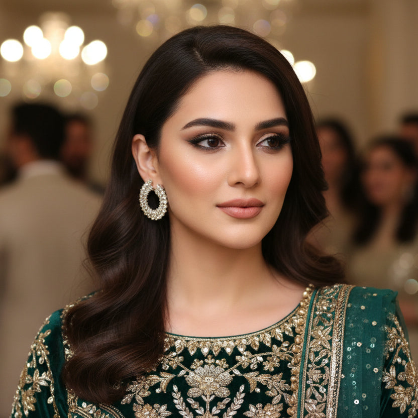 Pair of hoop earrings with clear stones on a dark gray background