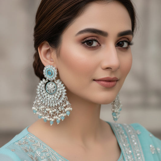 Pair of silver and blue beaded earrings on a dark background