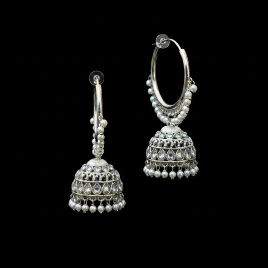 Silver hoop earrings with Jhumka designs on a black background