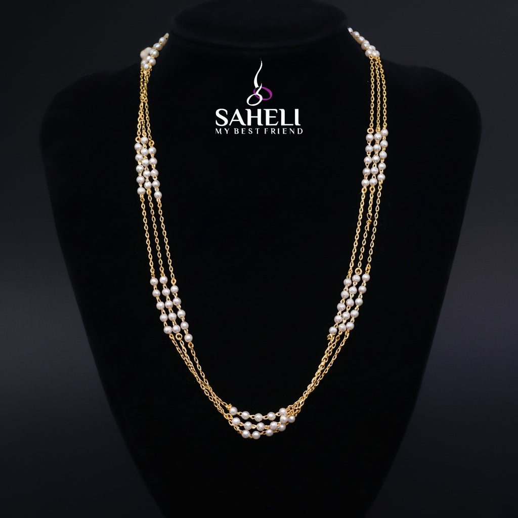 Pearl necklace on a black stand with 'Saheli' branding.