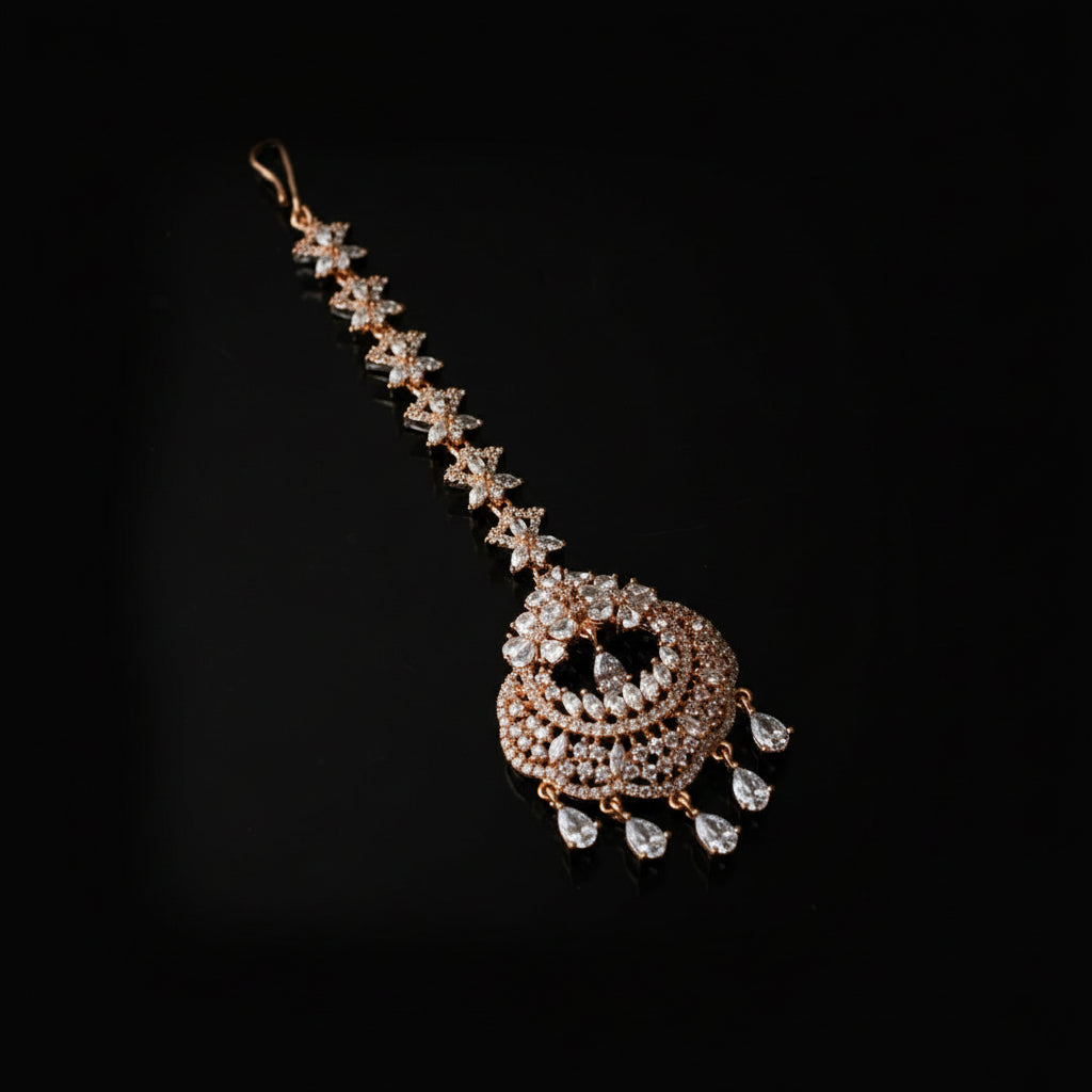 Decorative hair accessory with gold and crystal elements on a dark background