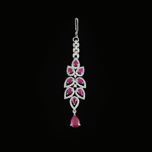 Silver pendant with pink gemstones on a gray background, featuring the brand 'Saheli'.