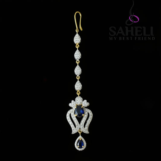Delicate necklace with gemstones on a dark background, featuring the brand 'Saheli'.