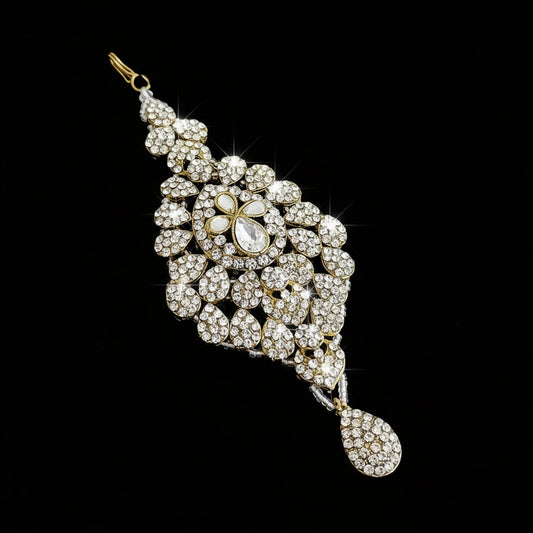 Ornate diamond and pearl pendant on a dark background with 'SAHELI' branding.