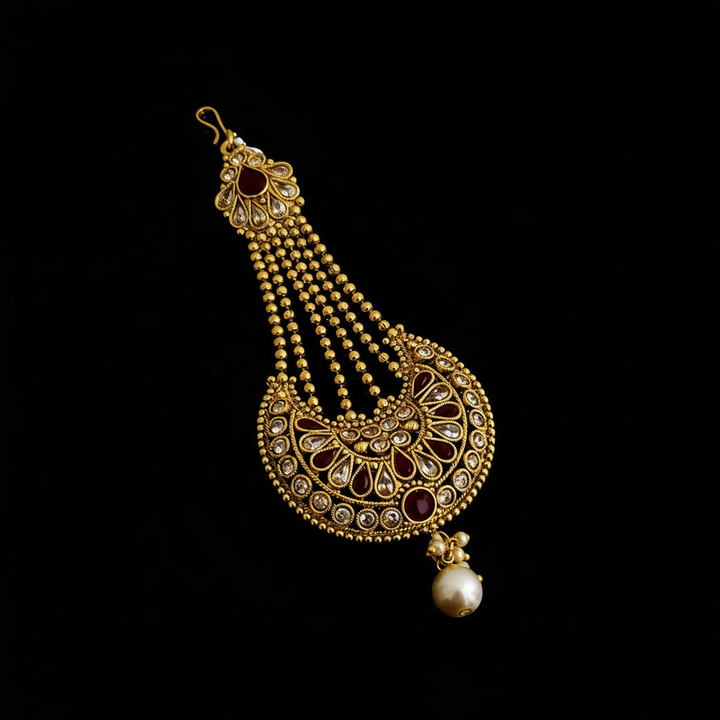Gold necklace with red stones on a dark background, featuring the brand 'SAHELI'.