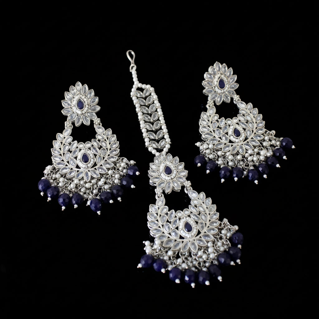 Silver and purple jewelry set on a dark background