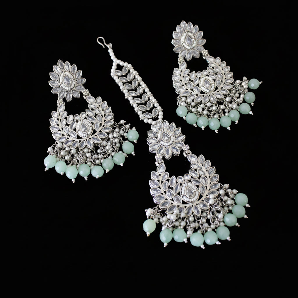 Set of silver and turquoise earrings on a dark background