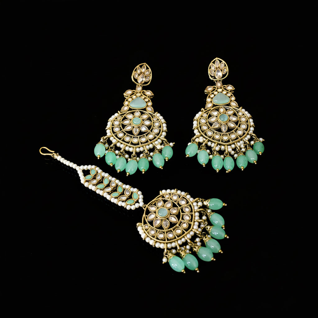 Ornate earrings with turquoise stones on a dark background, featuring the brand 'SAHELI'.