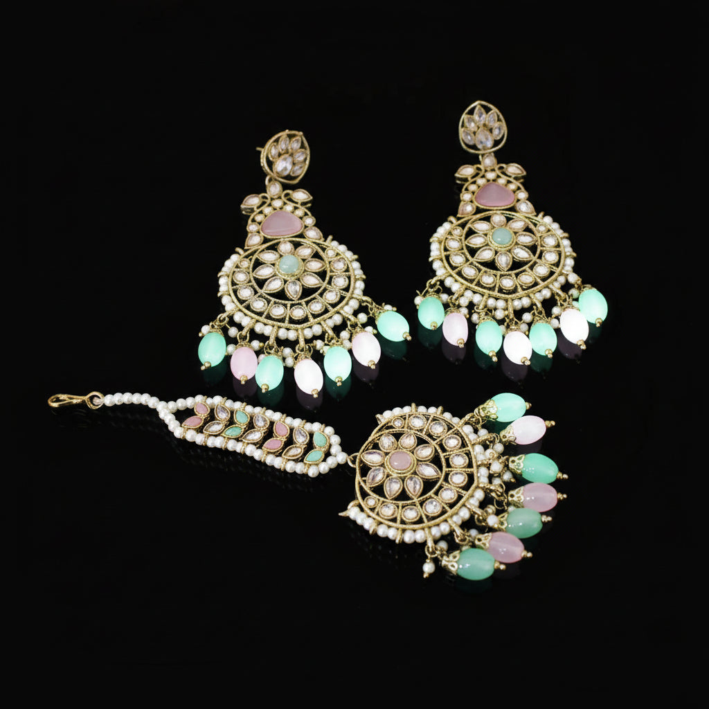 Ornate earrings with green and pink stones on a dark background, branded 'Saheli'.