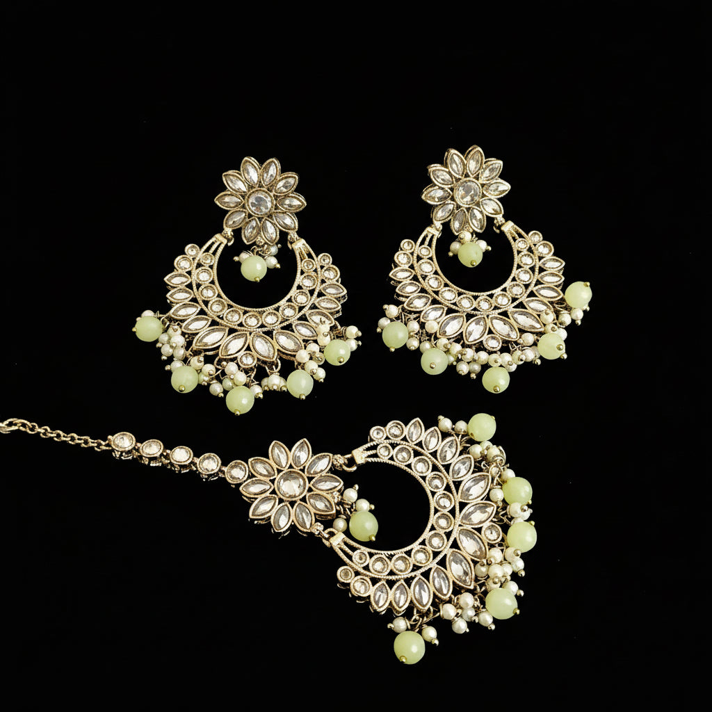 Ornate gold and green jewelry set on a dark background with 'SAHELI' branding.