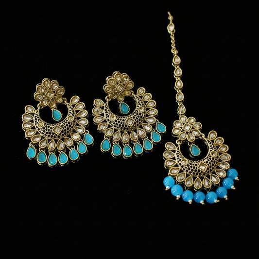 Jewelry set with gold and blue elements on a dark background, featuring the brand 'Saheli'.