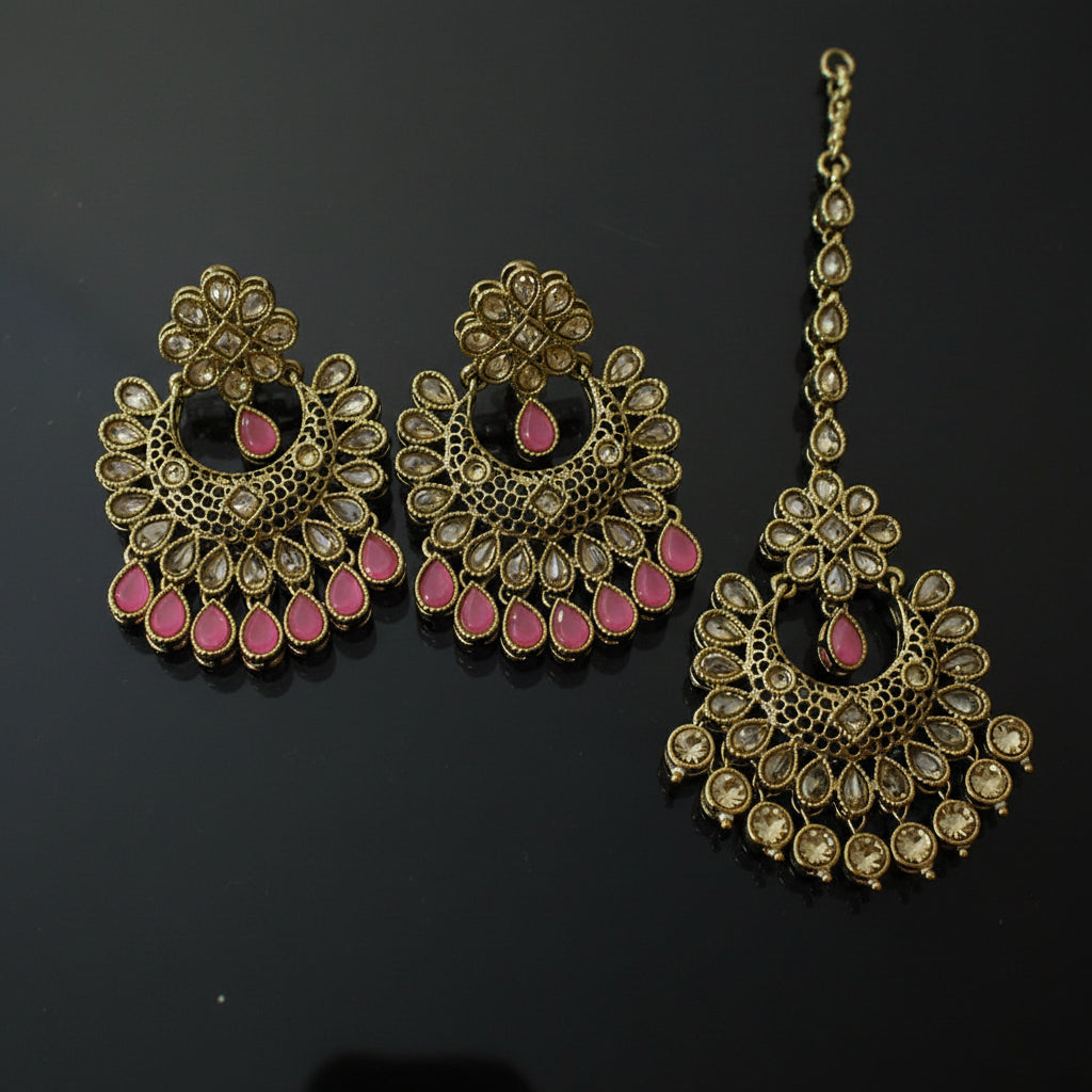 Ornate gold and pink earrings on a dark background with 'SAHELI' branding.