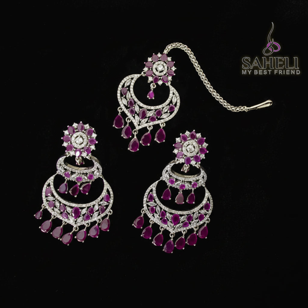 Jewelry set with pink and silver earrings on a black background