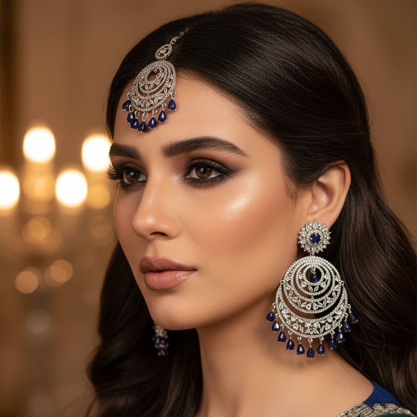 Silver jewelry set with earrings and a necklace on a dark background