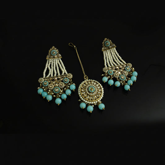Set of decorative earrings with turquoise beads and gold accents on a black background