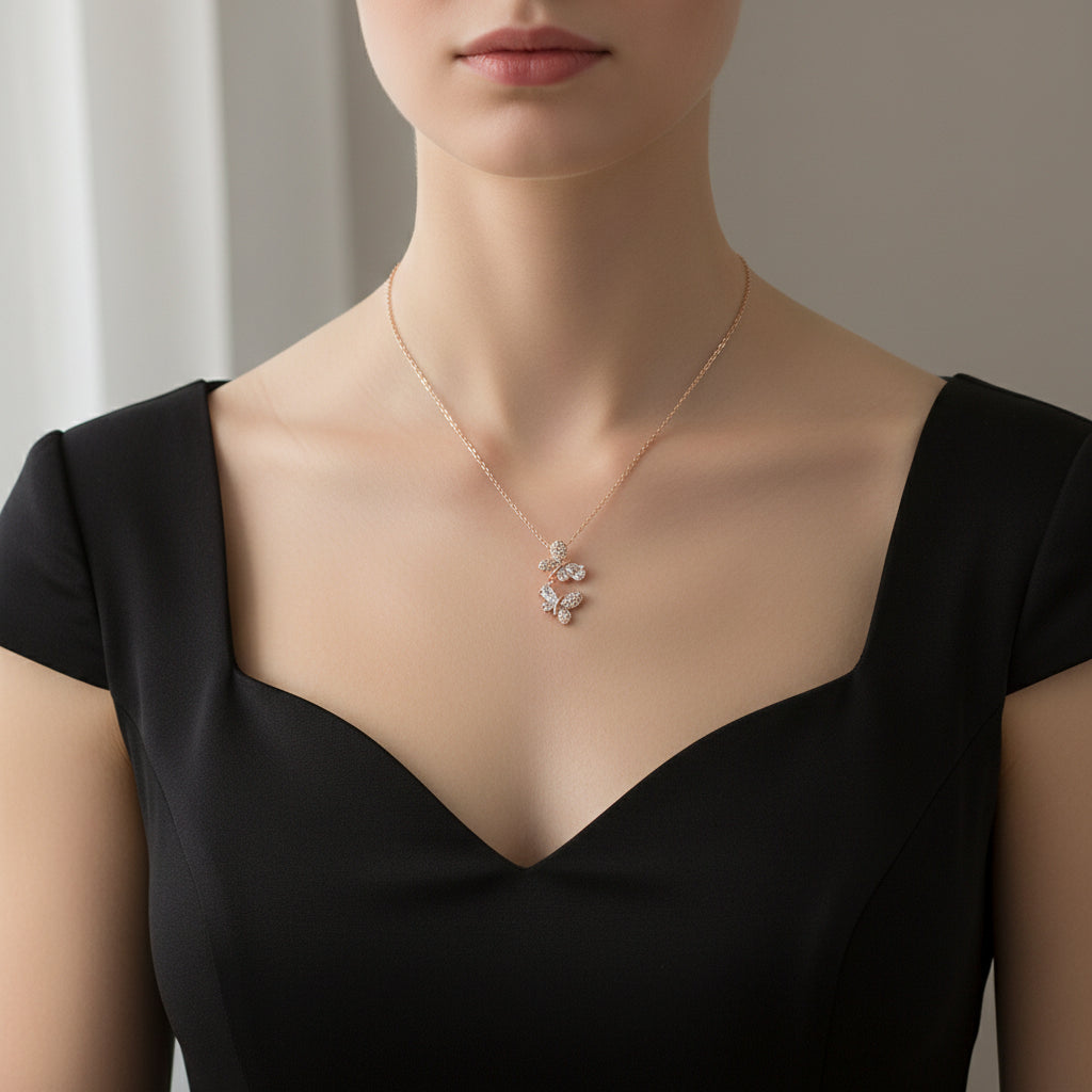 Rose gold necklace on a Saheili branded card against a dark background