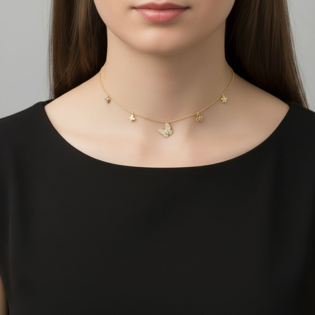 Gold butterfly necklace on a dark background