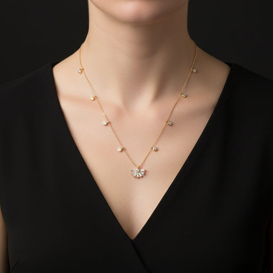 Gold necklace with a fan-shaped pendant on a dark background