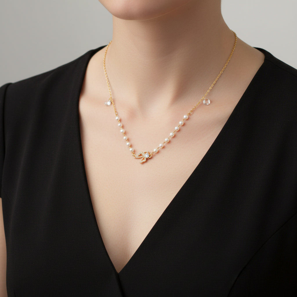 Pearl necklace with a gold clasp on a black background