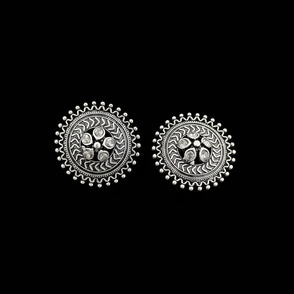 Pair of silver earrings on a gray background