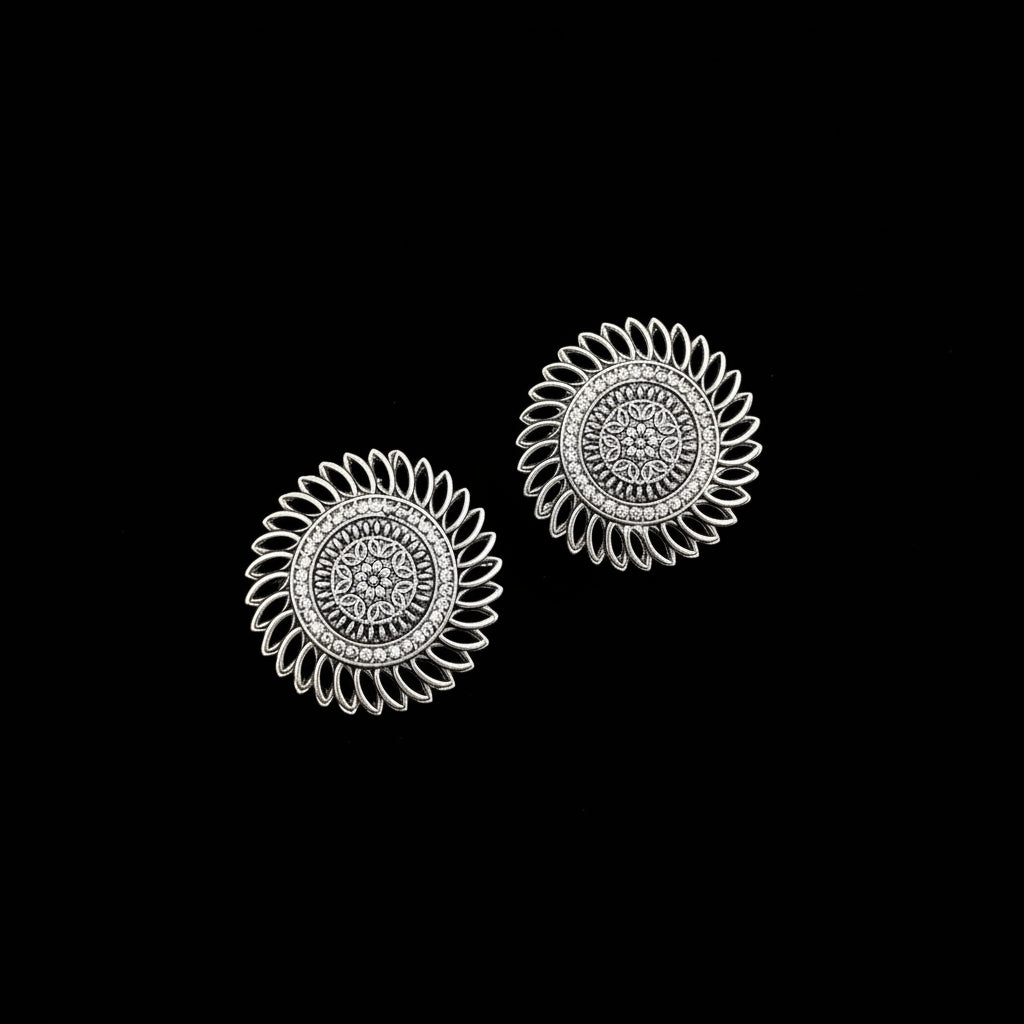Pair of silver floral earrings on a gray background