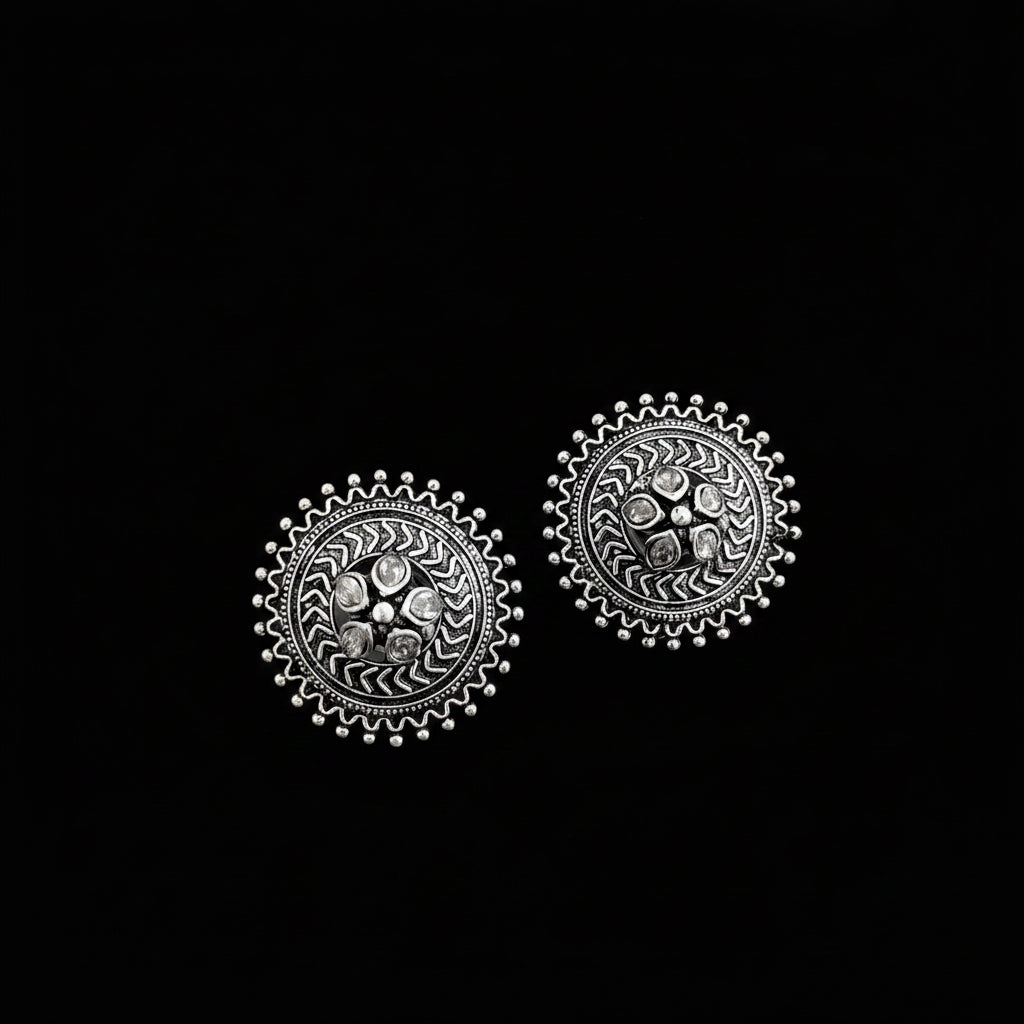 Pair of silver earrings on a gray background