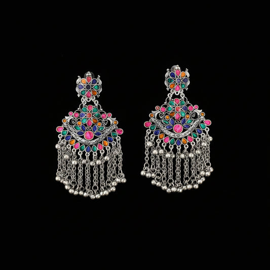 Colorful earrings with silver chains on a dark background