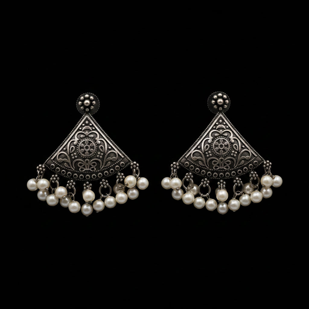 A pair of traditional Indian silver-toned filigree dangle earrings with white pearl bead drops, displayed on a light gray background with the brand logo 'SAHELL MY BEST FRIEND' above them.