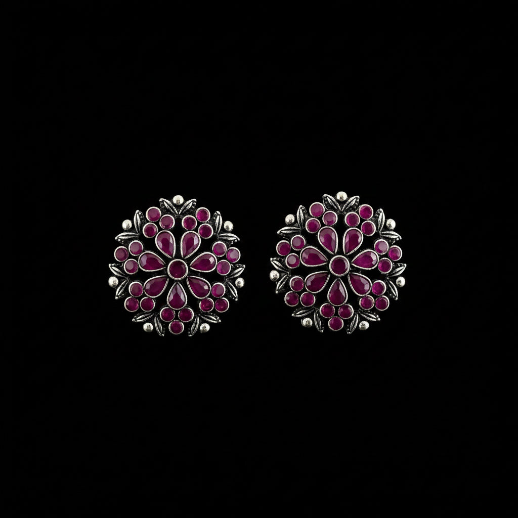 A pair of silver-toned Indian Kundan earrings decorated with pink and red stones, displayed on a dark gray reflective surface with the brand name 'SAHELI MY BEST FRIEND' printed at the top.
