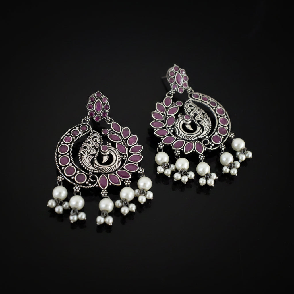 Ornate earrings with purple and white beads on a dark background