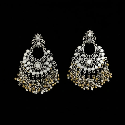 A pair of ornate silver-toned Indian jhumka earrings decorated with white faux pearls and gold-toned beads, displayed on a dark reflective surface with a 'SAHIEL MY BEST FRIEND' watermark.